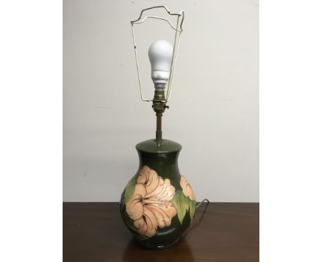 A Moorcroft green with pink flowers table lamp base. IMPORTANT: Online viewing and bidding only. Collection by appointment vi