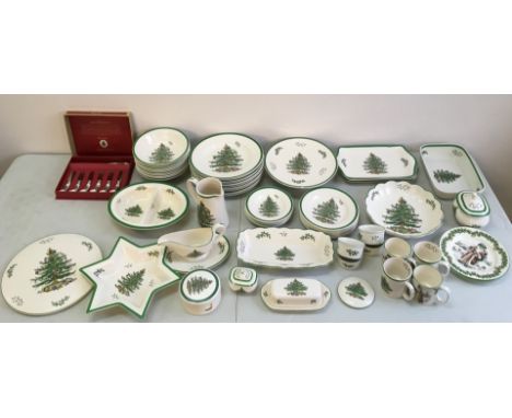 A collection of Spode Christmas Tree China, to include plates, mugs, saucers, jugs, butter knives, and serving dishes. IMPORT