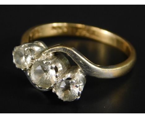 A three stone diamond ring, with central diamond approx 0.15cts, flanked by two smaller stones, each approx 0.1cts, yellow me