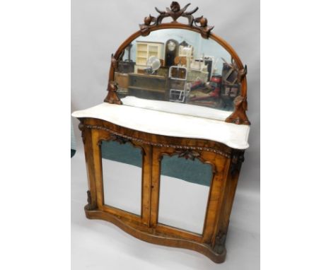 A Victorian rosewood side cabinet, the raised back with a collared edge carved with stylised flowers, berries etc, the serpen