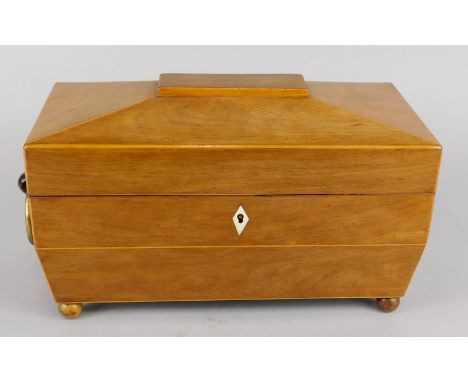 A George IV rosewood tea caddy, the hinged lid enclosing two lidded compartments, the base with brass ring handles, 32cm wide