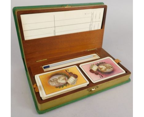 An early 20thC leather bridge box, containing playing cards, scorers etc.