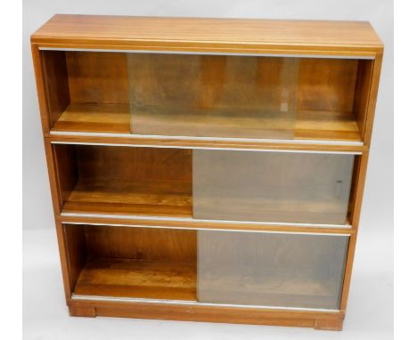 A 1960s-70s teak sectional bookcase,  with glass and aluminium sliding doors on plinth base, 88cm wide.