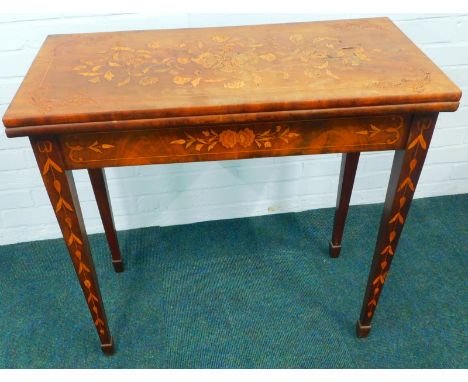 An early 19thC Dutch mahogany and floral marquetry card table, the rectangular top hinged to reveal a circular interior with 