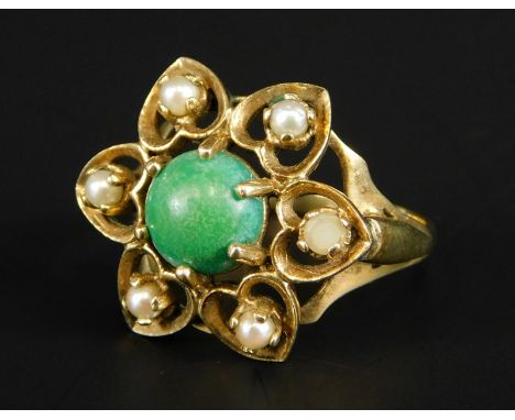 A 9ct gold dress ring, set with central green/blue turquoise stone, surrounded by six seed pearls, forming a floral cluster, 