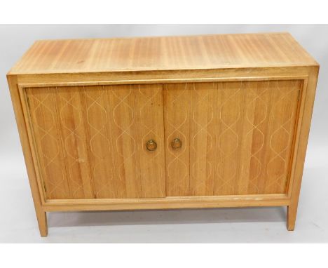 A Gordon Russell double Helix teak sideboard, designed by John Booth and Judith Ledeboer with two doors enclosing a shelf wit