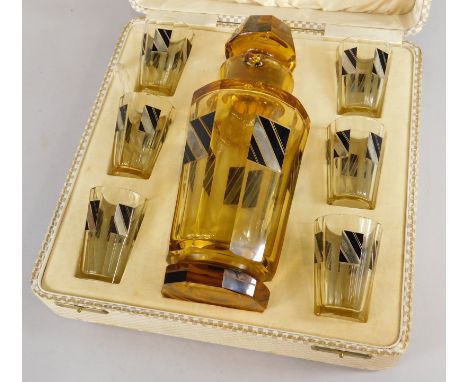 A Bohemian Art Deco period amber tinted decanter stopper and six matching glasses, each with black and silvered metallic over
