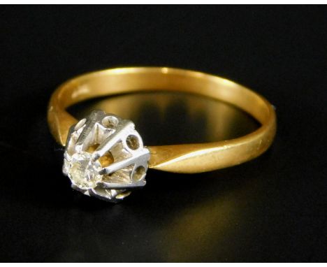 A diamond solitaire ring, in illusion set raised mount, the stone approx 0.06cts, yellow metal, marked 18ct, 2.2g all in. 