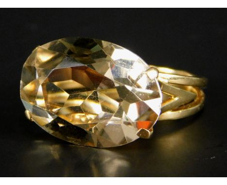 A dress ring, set with large oval smoky quartz stone, yellow metal band, unmarked, boxed. 