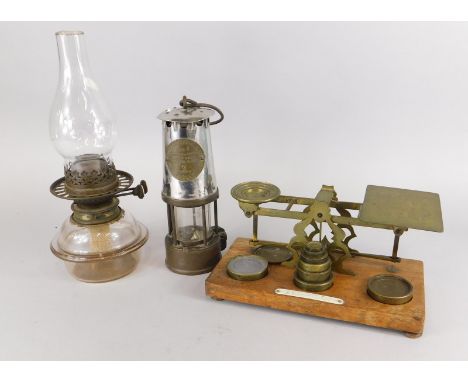 A set of brass postage scales with weights, a protector miner's lamp etc.