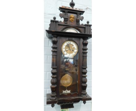 A Vienna style walnut wall clock, with enamel type dial, 101cm high.