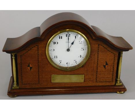 An Edwardian mahogany and parquetry mantel timepiece, the enamel dial signed Mansell Lincoln, the case with brass pillars and