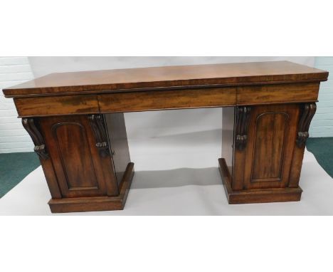 An early Victorian mahogany pedestal sideboard, the rectangular top with three frieze drawers, above two panelled doors, flan