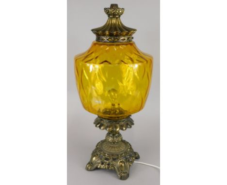 A Continental gilt metal lamp base, with amber tinted shade and pierced leaf cast base