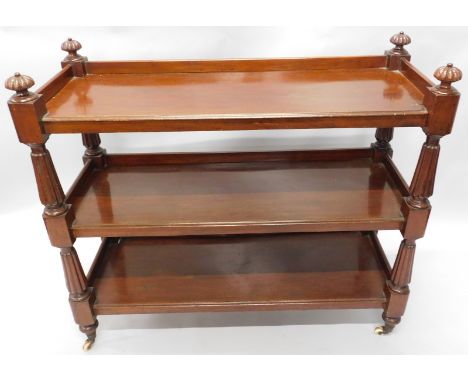 A Victorian mahogany dinner wagon or buffet, the top with turned finials and three quarter gallery, above two further tiers, 