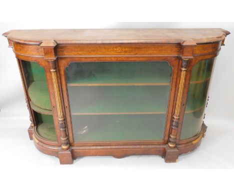 A Victorian figured walnut credenza, the top with a moulded edge and bow fronted end sections, above a central glazed door, f