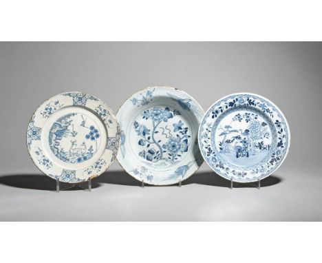 Two delftware plates  c.1760, one Bristol and painted in blue with two cranes standing beside an ornamental fence and floweri
