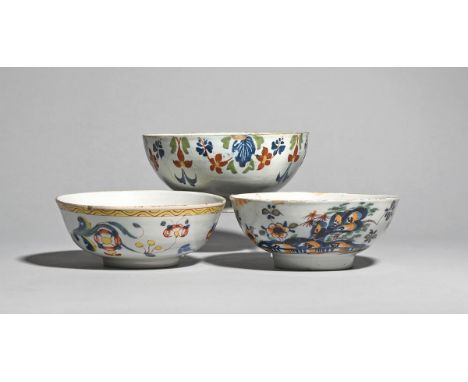 Three delftware bowls  c.1740-60, probably London, one painted in bright enamels with flying insects and flowering branches w