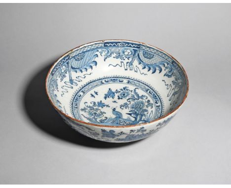 A massive delftware punch bowl  c.1760-80, of exceptional size, the interior painted in blue with an exotic bird perched on a