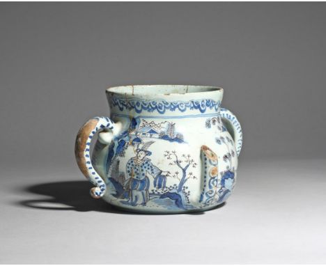 A delftware posset pot  c.1680, Brislington or London, of large size, painted in blue and manganese with a figure wearing an 