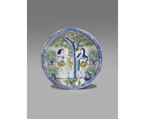 A Bristol delftware Adam and Eve charger  c.1730-40, painted with the scene of the Temptation, the doomed couple flanking the