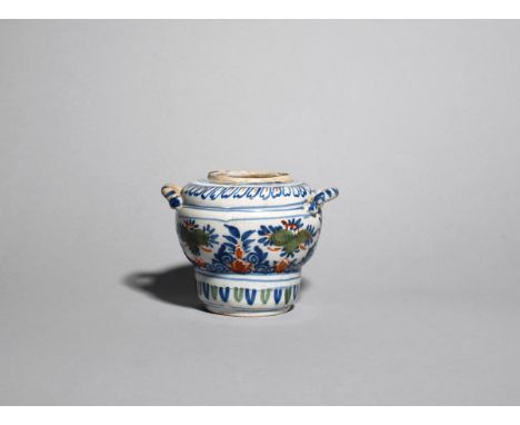 A delftware two-handled storage jar  c.1705-15, of bulbous shape, painted in red, blue and green with a formal floral design 