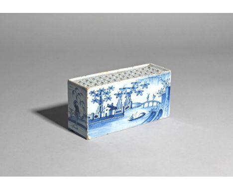 A delftware flower brick of exceptionally large size  c.1760, probably Bristol, the rectangular form painted in blue with two