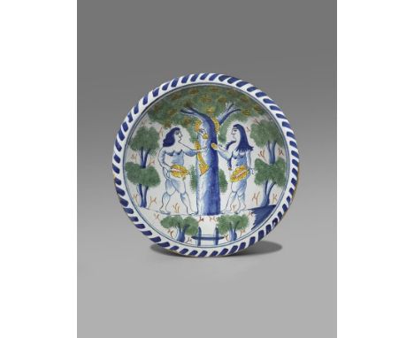 A Bristol or Brislington blue dash charger  c.1730-40, painted with 'The Temptation', Adam and Eve flanking the Tree of Knowl