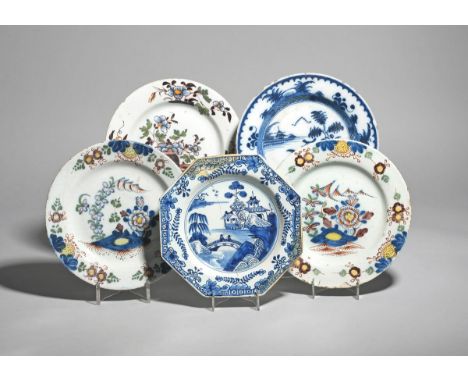 Five delftware plates  mid 18th century, including a pair of plates painted in polychrome enamels with flowering branches iss