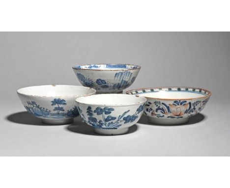Four delftware slop bowls  mid 18th century, the smaller Bristol and painted in blue with flowering Oriental plants, one bowl