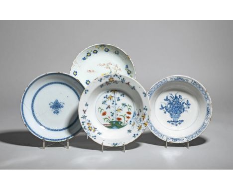 Four delftware bowls  mid 18th century, the shallow forms variously decorated in blue and polychrome enamels with vases of fl