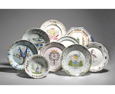 Seven French faïence plates  probably 19th century, four decorated with Revolutionary subjects including a putto holding a ba