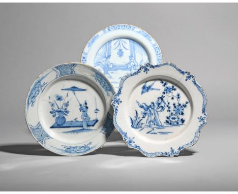 Three delftware plates  c.1750, one painted in blue with a Chinese boy jumping to catch a bird, beside a lady and flowering p