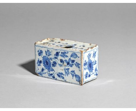 A small delftware flower brick  c.1750, the rectangular form painted with flowering mimosa sprays to all four sides, the rece