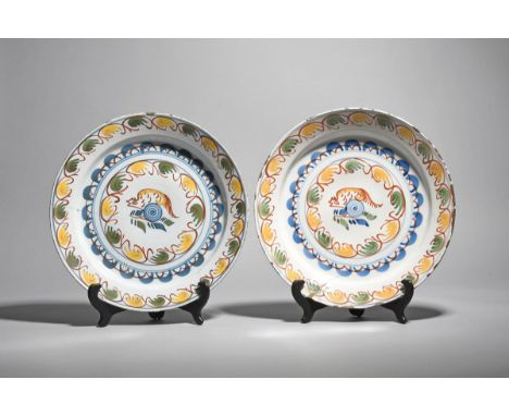A pair of delftware polychrome chargers  c.1730, possibly London, painted in blue, red, yellow and green, each with a stylize
