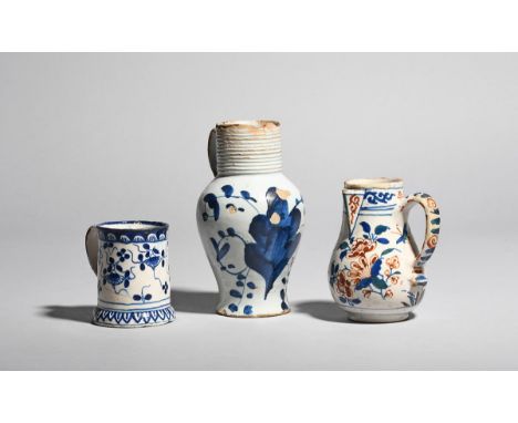 A small delftware jug  c.1700-20, painted in red, green and blue with a bird in flight above flowering branches, the side han