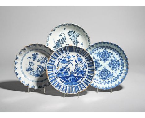 Four delftware shallow bowls  c.1710-50, Lambeth and Bristol, two moulded with fluted and painted in blue with flower arrange
