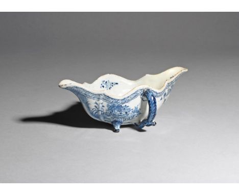 A rare delftware two-handled sauceboat  c.1760-70, the double-ended form painted in blue with a figure in a boat in a Chinese