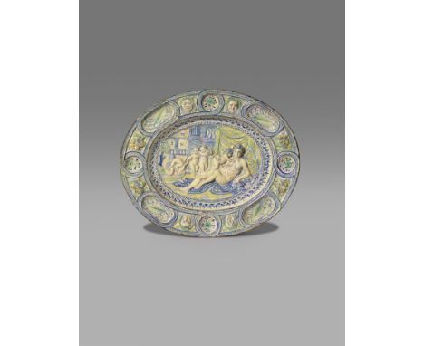 A rare and early delftware Fecundity dish  dated 1638, the oval form moulded in high relief with Venus reclining and attended