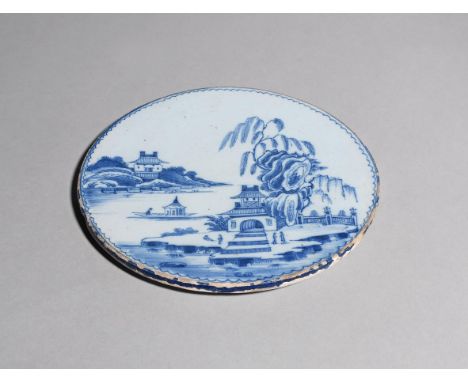 A rare delftware stand or trivet  c.1720-40, the flat circular form painted in blue with figures in a pagoda island scene, pr