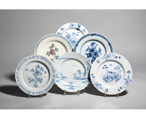 Six delftware plates  mid 18th century, one painted in blue with peony beside an ornamental fence, another with figures in a 