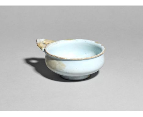 A delftware bleeding bowl or porringer  c.1680-1700, the shallow circular form with a single handle pierced with a heart, dec
