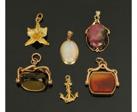 Two 9 ct gold swivel fobs, an opal pendant stamped "585", a 9 ct gold anchor charm, a gold coloured metal daffodil pendant an