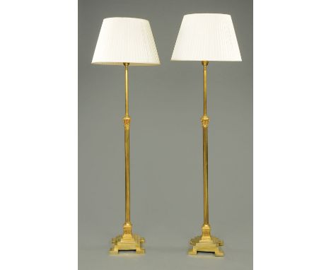 A pair of 19th century brass lamp standards, with Corinthian capitals, adjustable, all raised on square stepped bases, height