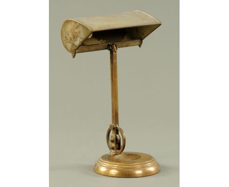 A brass table lamp, early 20th century, with adjustable shade on square stem sprung adjustable at the base, on circular stepp