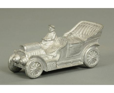 A novelty inkwell in the form of a Vintage car, circa 1900/1910, modelled with a driver wearing cap and goggles, the rear for