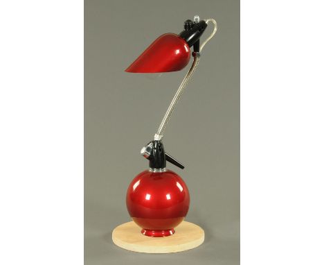 An amusing desk lamp, constructed from a soda siphon, with deep red shade and body.  Height 58.5 cm. 