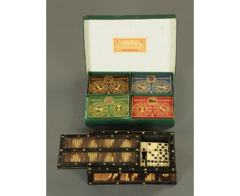 A porcupine quill box, containing dominoes, length 18 cm, and a cased bezique set. 