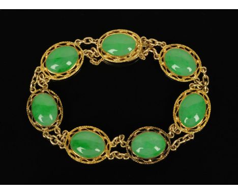 A Chinese jade bracelet, with seven cabochons each in pierced setting (see illustration).   CONDITION REPORT:  The bracelet i
