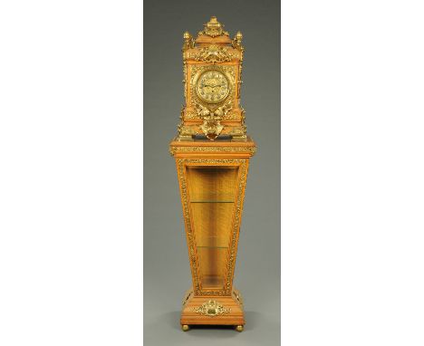A fine Victorian oak clock, raised on an inverted tapering pedestal, the three-train fusee movement striking on eight bells a